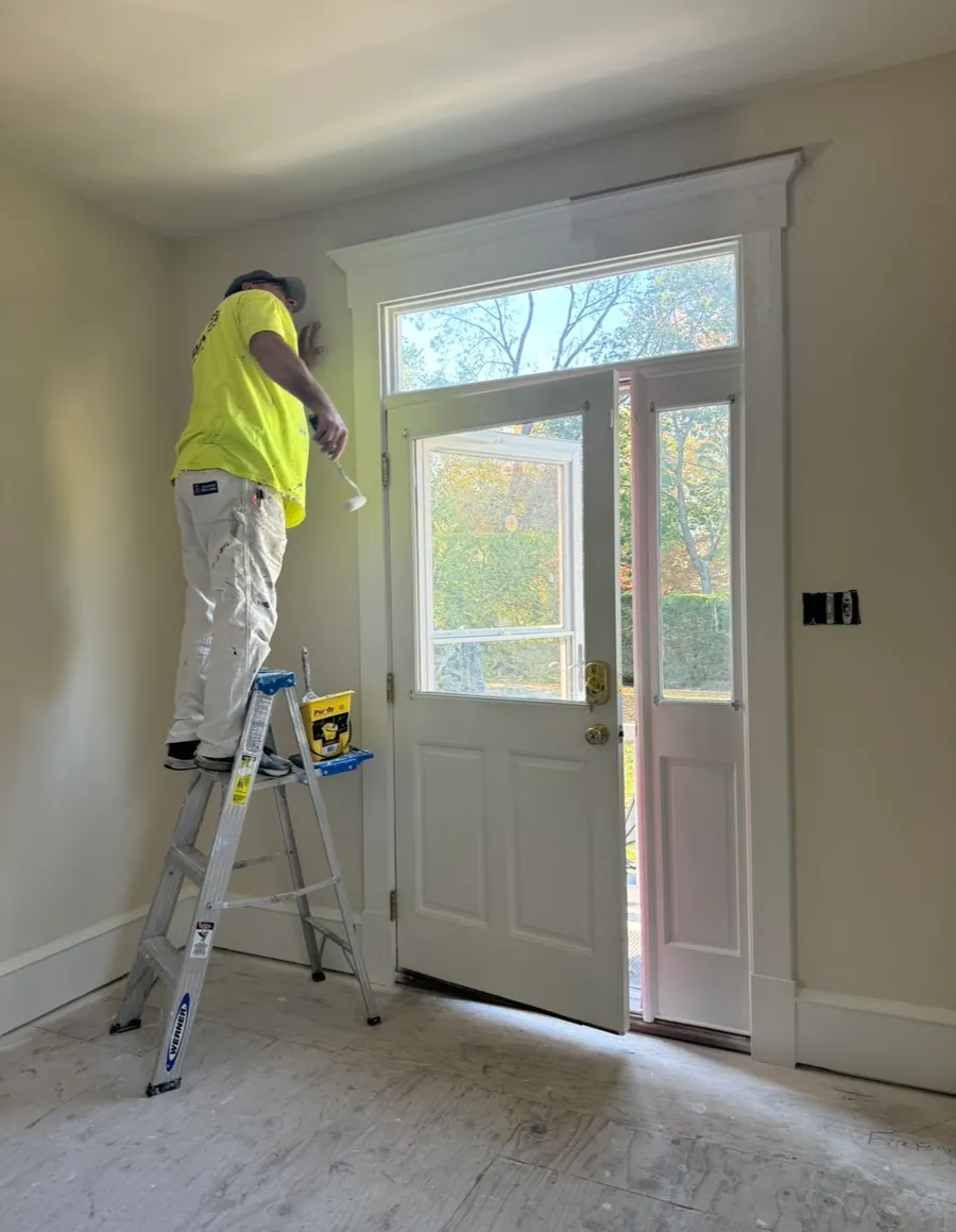 Painter cutting in beside a door