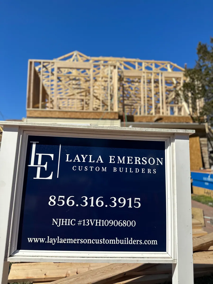 Company sign in front of a framed addition