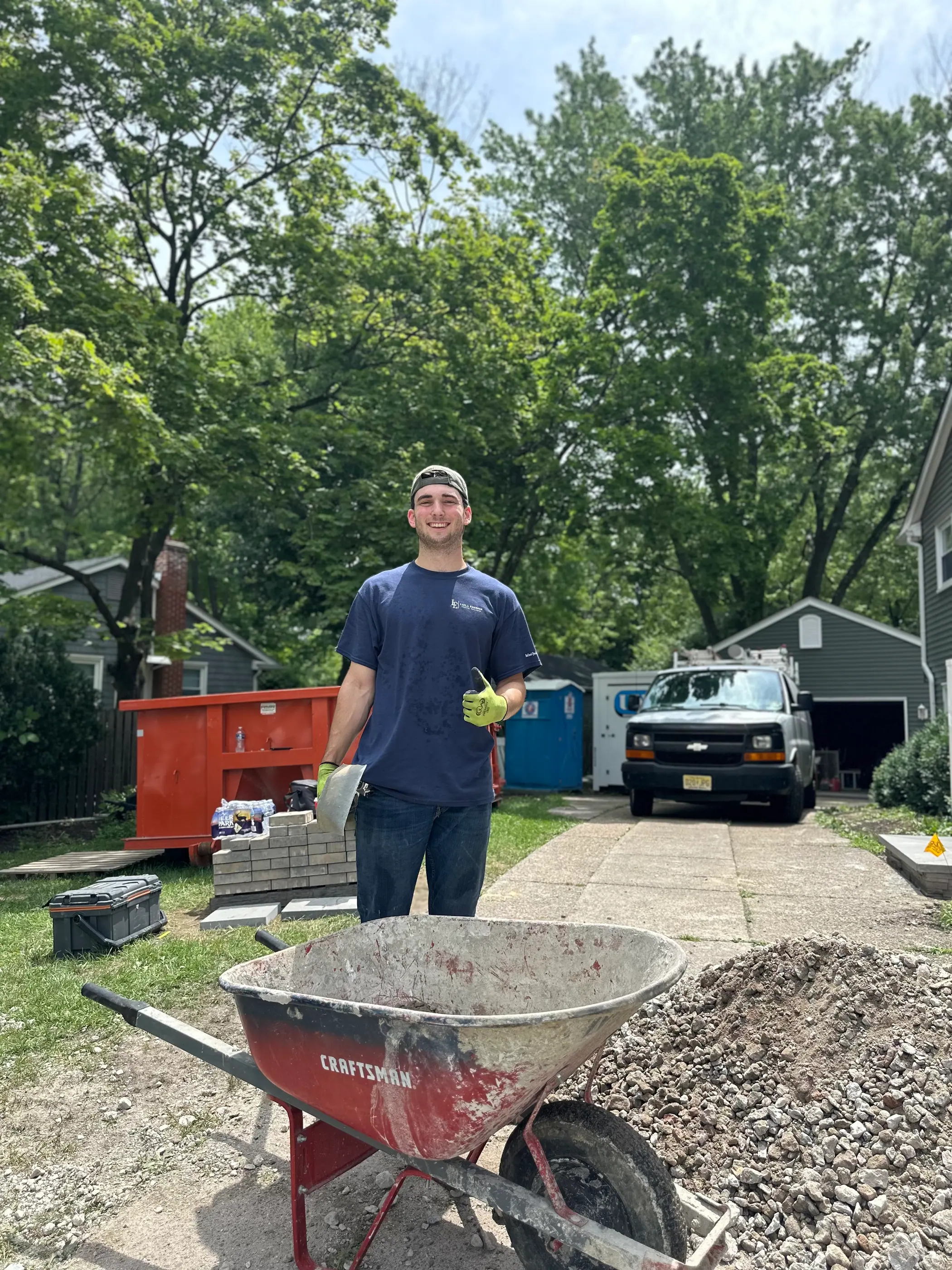 Crew member moving material across a site