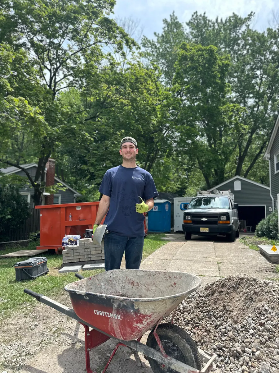 Crew member moving material across a site